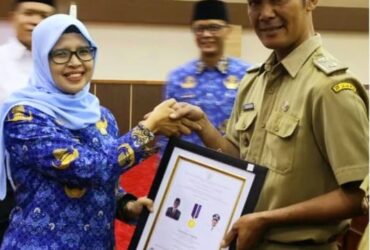Bupati Blitar Hj. Rini Syarifah menyerahkan penghargaan dari Kemendesa PDTT kepada desa atas komitmen dan kerja keras dalam mewujudkan Desa Mandiri tahun 2023. (blok-a.com/Fajar)
